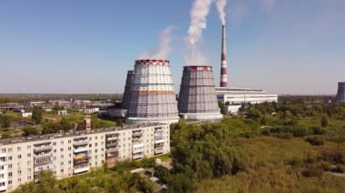 Combined heat and power CHP plant. Thermal power. Residential heat supply. Water cooling towers, big steam and smoke pipes. Thermal power plant aerial 4k view 