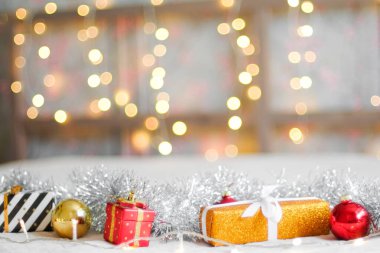 Gifts and Christmas decorations against the garland lights background. New Year and Christmas concept. Waiting for the holiday.