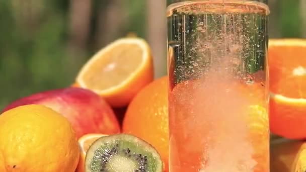 물컵에 복제품 알약들 비타민을 합성할 수있다 과일의 배경에 유리잔의 — 비디오
