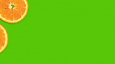 Arka planda, yeşil arka planda portakal dilimleri görünüyor. Flaşlı arka plan. Meyvemsi arka plan, sulu narenciye dilimleri.