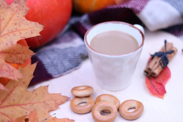 A cup of coffee or cocoa against the background of an autumn composition, still life. Harvest season, bright colors