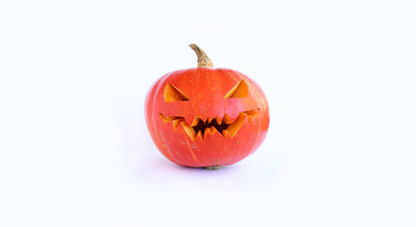 Halloween pumpkin isolated on white background. Ripe orange pumpkin for Halloween on a light background. An element of festive decor, a pumpkin with a carved scary face