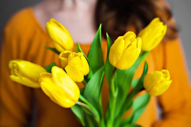 Genç bir kız yatakta gevrek ve lezzetli bir tahıl gevreği tutuyor. Sabahları evde sağlıklı ve lezzetli bir kahvaltı. Yakın plan. Seçici odak.