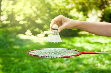 Kadın eli badminton oynamak için servis aletini raketin üstünde tutuyor. Sağlıklı yaşam tarzını kabul et. Fitness konsepti. Yakın plan.. 