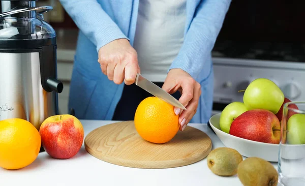 Young Woman Cuts Ripe Orange Making Fresh Juice Kitchen Home — Zdjęcie stockowe