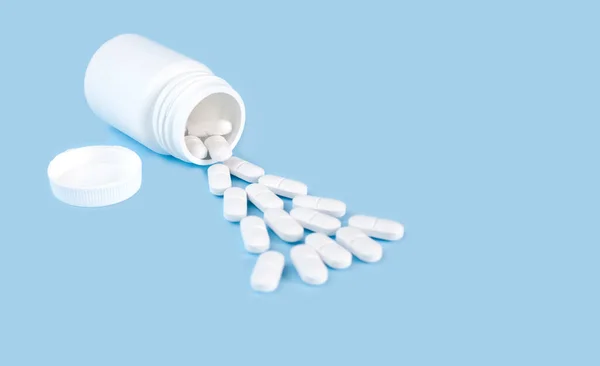 White Pills Poured Out Bottle Blue Background Medicine Concept Place — Stock Fotó