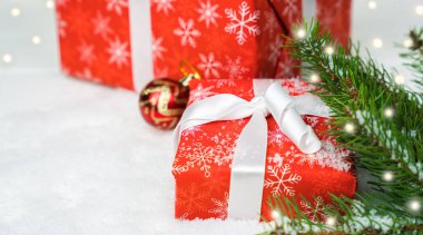 Noel hediye kutuları ve karda Noel ağacı. Yakın plan. Yeni yıl ve Noel hediyeleri. Metin için yer.
