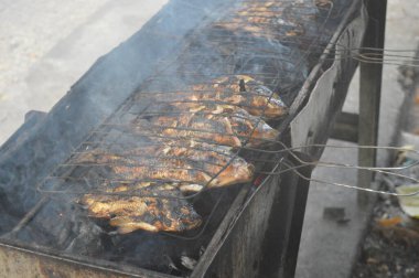 Seçici odaklanma, ızgara yapılan Tilapia balığı, muz yapraklarına sarılmış ızgara balık yemekleri..
