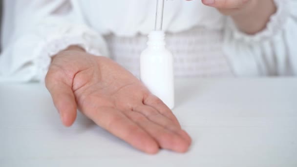 Asian Woman Holding Eye Dropper Dropping Serum Bottle Isolated White — Stockvideo