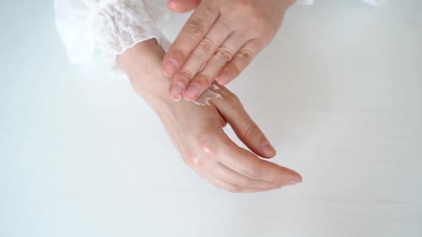 Woman Rubs Cream Her Hands Close White Background High Quality — Vídeo de Stock
