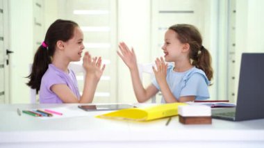 Two funny little kids playing home having fun with, children and gadget concept. High quality 4k footage