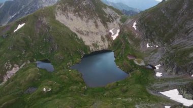 Dawn in the mountains, tourist tents from a birds eye view. Camping tourists in the mountains. Tent camp in the mountains. Hiking in the mountains. High quality 4k footage