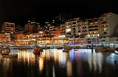 SAINT JULIAN 'IN MALTA, 22 AĞUSTOS 2022: Aziz Julian' ın Malta kasabasındaki Spinola Körfezi gece manzarası. Düzenleyici kullanımı. 