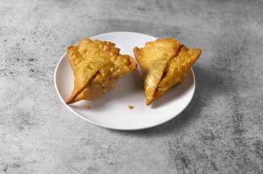 Gri arkaplanda iki samosa. Geleneksel Hint yemekleri. Samosa baharatlı samosa 'nın güzel bir resmi..