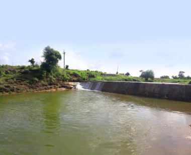 Selective focus, selective focus on subject, Blur background Beautiful landscape of Check Dams In The gir forest Forest Gujarat India. also called lacustrine. blue sky, small river, Lake, check dam.