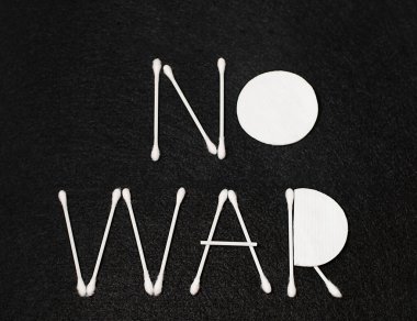 The inscription No to war with white sticks on a black background. Creative. Minimalism. Close-up. Concept.