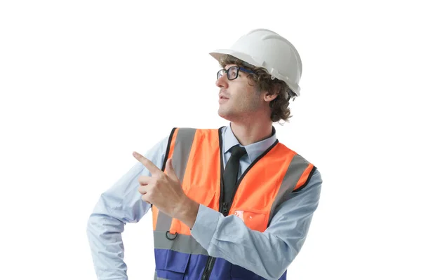 头戴硬礼帽 身穿安全制服的高加索工程师 建筑工人的画像 严肃地指向带有白色背景的复制空间 — 图库照片