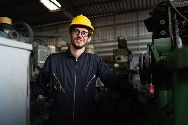 Portrait of optimistic industrial worker stand and smiling with confident at industrial site factory, concept manufacturing industry, engineering worker profession.