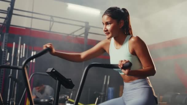 Hip Level Shot Asian Woman Exercising Air Bike Gym — Stockvideo