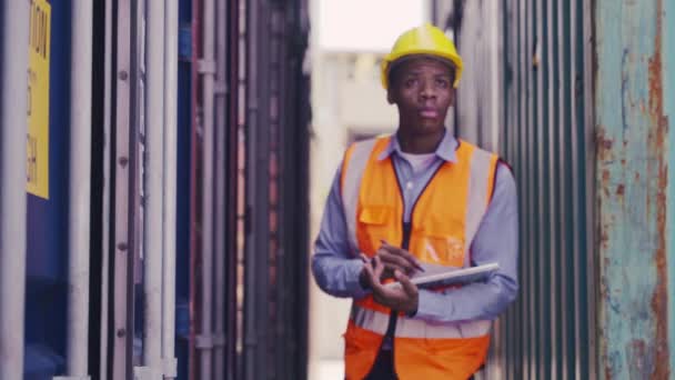 Medium Shot Black Man Industrial Shipping Worker Checking Container Stack — Vídeos de Stock