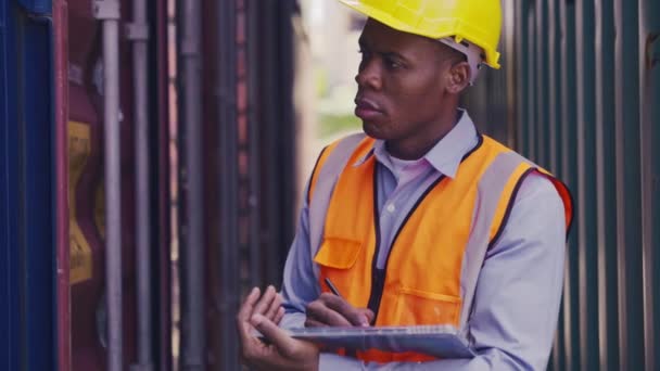 Medium Shot Black Man Industrial Shipping Worker Checking Container Stack — Αρχείο Βίντεο