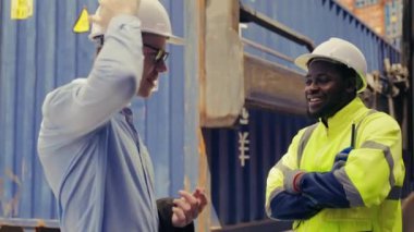 Closeup shot Businessman and Industrial shipping worker discuss together at container yard, Logistics supply planning and management for international goods import export.
