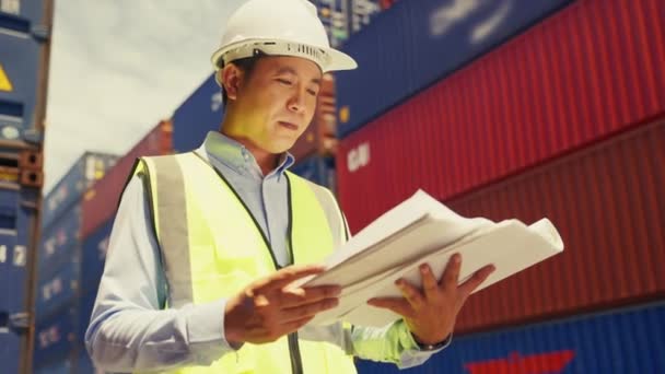 Medium Shot Asian Man Industrial Shipping Worker Holding Document Look — Vídeo de stock