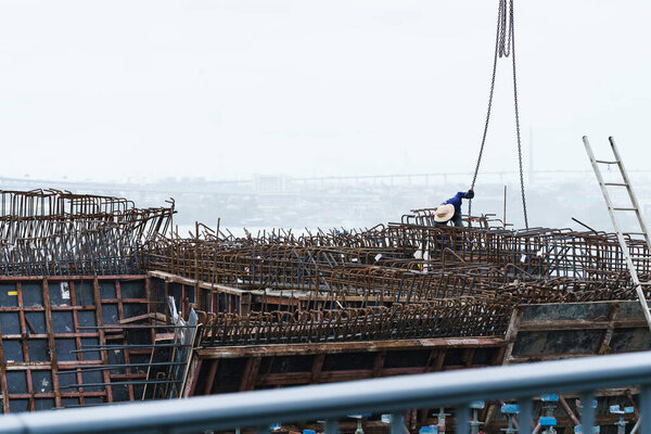 Construction at high zone with un identify labor people working in the area. the man working at risky building skyline area.