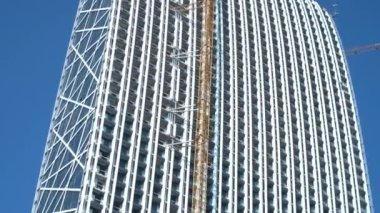 Facade closeup shot construction of high modern futuristic commercial building. High quality 4k footage