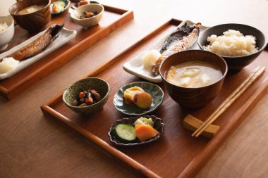Healthy traditional Japanese breakfast in the 'ichiju-sansai' that has three dishes (one soup and three dishes) served on the table.