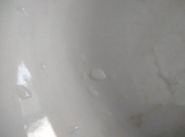 Üzerinde su damlaları olan beyaz bardağın güzel arka planı.