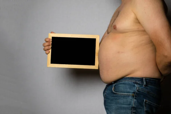 Overweight Shirtless Caucasian Man Standing Sideways Holding Blackboard — Stock Fotó