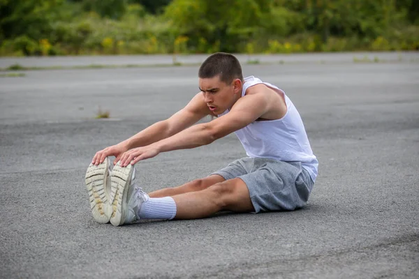 Nineteen Year Old Teenage Boy Stretching Public Park - Stock-foto