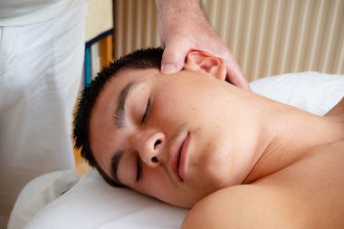 A Nineteen Year Old Teenage Boy Having A Head and Neck MAssage