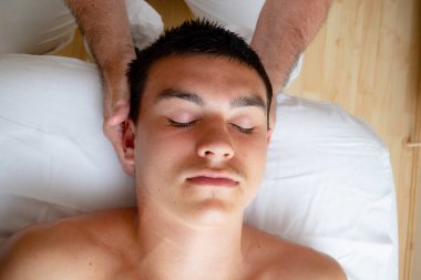 A Nineteen Year Old Teenage Boy Having A Head and Neck MAssage