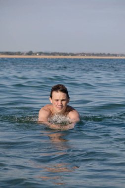 A 17 Year Old Teenage Boy Swimming In The Sea
