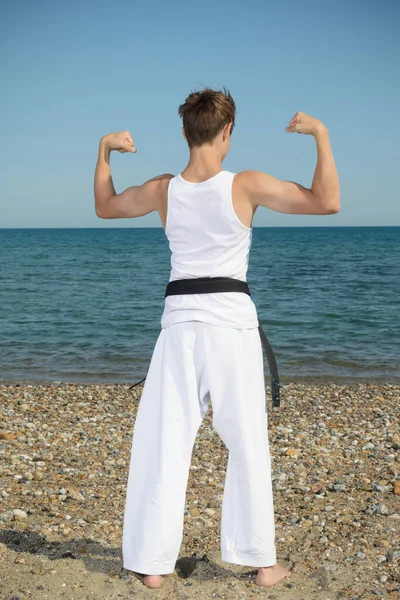 Year Old Teenage Black Belt Flexing His Muscles Beach — Stock Fotó