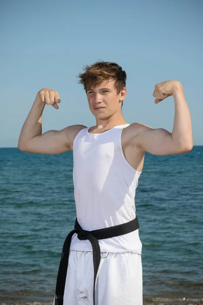 Year Old Teenage Black Belt Flexing His Muscles Beach — Stok fotoğraf