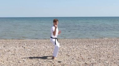 Teenage Boy Doing Karate on A Beach