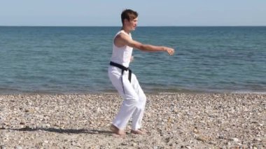 Teenage Boy Doing Karate on A Beach