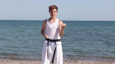 Teenage Boy Doing Karate on A Beach