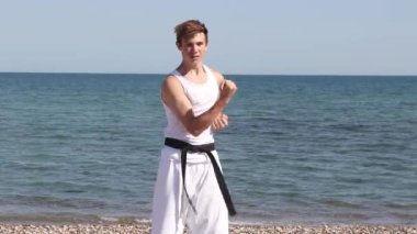 Teenage Boy Doing Karate on A Beach