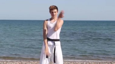 Teenage Boy Doing Karate on A Beach
