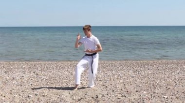 Teenage Boy Doing Karate on A Beach