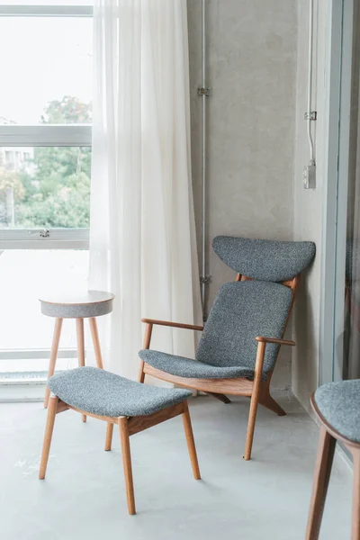 Minimalist relaxrooms with chair and accessories in the room.