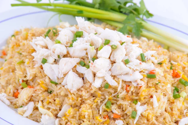 Crab fried rice on the white dish.