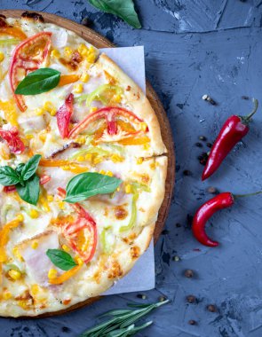 pizza with brisket, sausages, tomatoes and olives