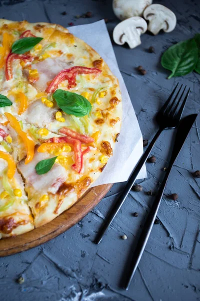 Göğüs eti, sosis, domates ve zeytinli pizza.