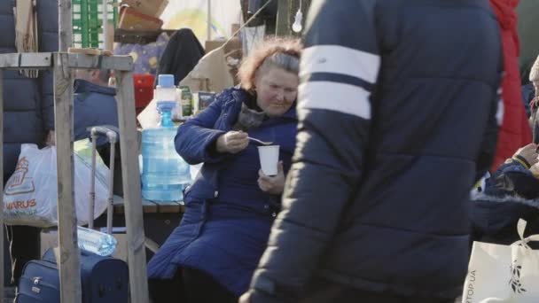 Lviv, Ukraine - March 15, 2022: Refugees at the railway station of Lviv waiting for the train. Little child sitting with his mother and eating after leaving home. — Stock Video