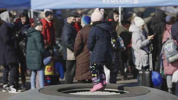 Lviv, Ukrayna - 15 Mart 2022: Ukrayna 'nın batısındaki Lviv kentindeki tren istasyonu yakınlarındaki doğu Ukrayna' dan tahliye edilenler. Sokakta duran küçük kız.